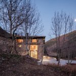 Casa entre el rio árboles y noche